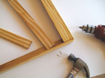 2. Cross pieces of 1/4-inch flat trim create supports for the bottom of the frame. The wire mesh will lie on them. We used 5 cross pieces–1 at each end and 3 equally spaced in the middle.